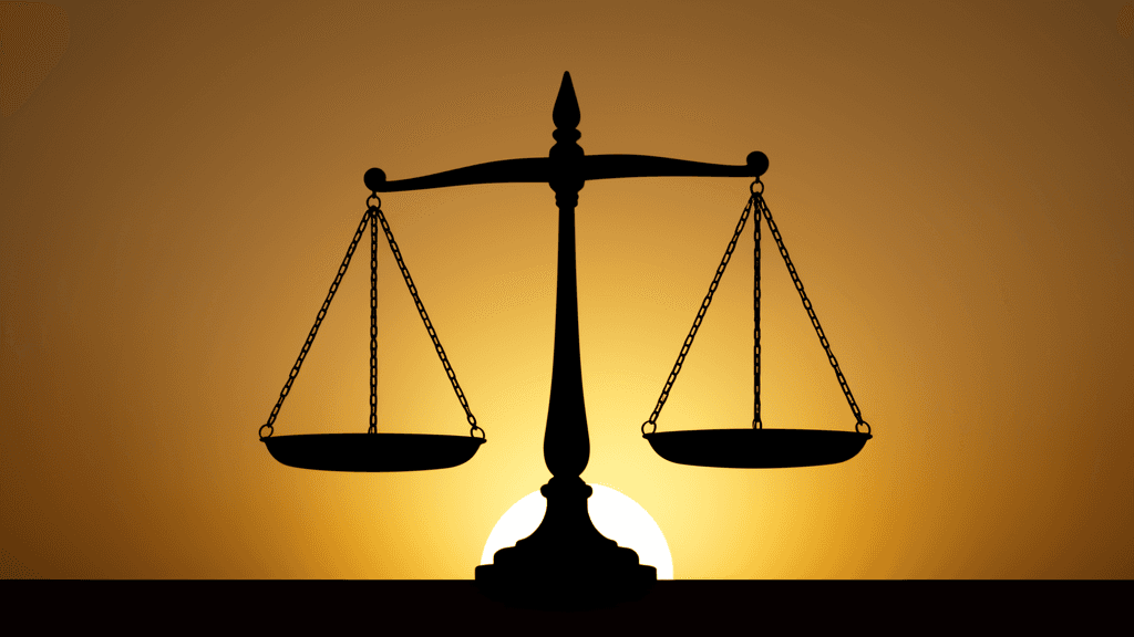 Scales of justice silhouette against golden sunset, representing California education governance reform — illustration, Jake Team LLC