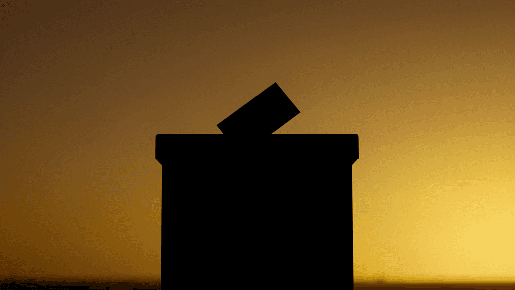 Ballot box silhouette against California sunset, representing California election results — illustration, Jake Team LLC